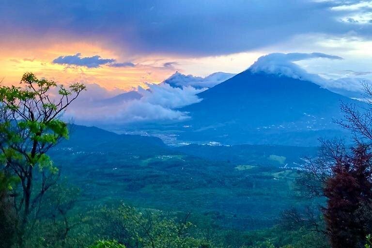The Antigua valley at first light with the volcanoes above the forest